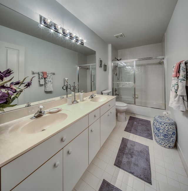 full bathroom with toilet, bath / shower combo with glass door, tile patterned flooring, and vanity