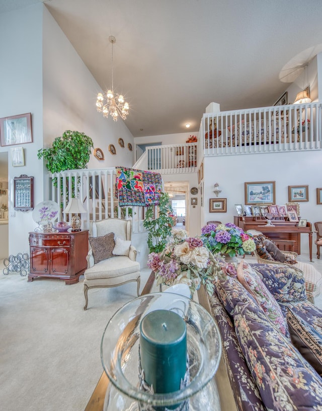 living room with an inviting chandelier, carpet, and high vaulted ceiling