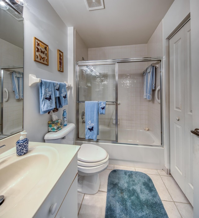 full bathroom featuring toilet, tile patterned floors, vanity, and shower / bath combination with glass door