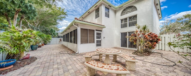 view of patio featuring a sunroom