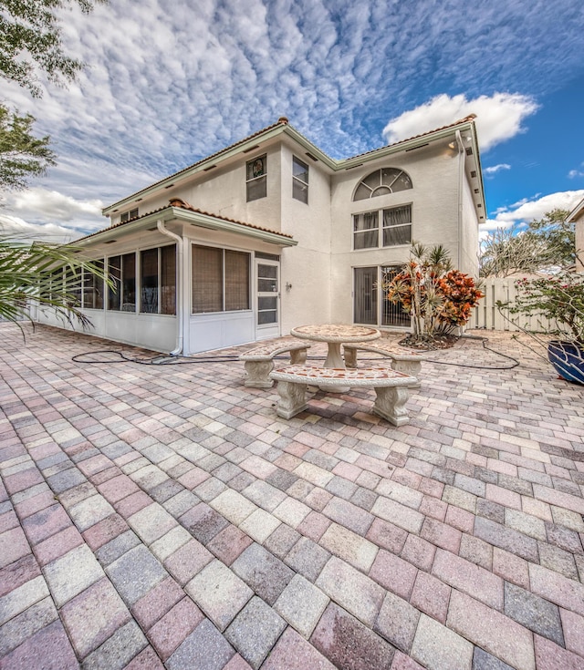 back of house with a patio area and a sunroom