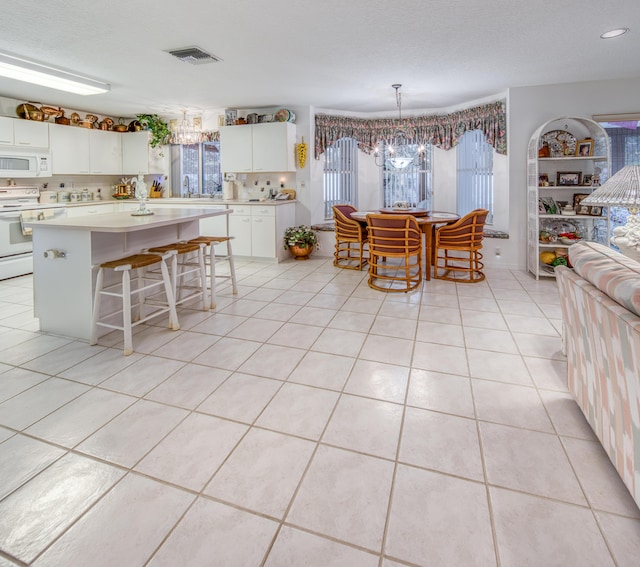 unfurnished dining area with light tile patterned flooring and a chandelier