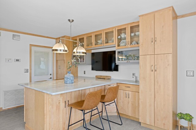 kitchen with pendant lighting, appliances with stainless steel finishes, ornamental molding, decorative backsplash, and light brown cabinets