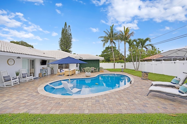 view of swimming pool with a patio area