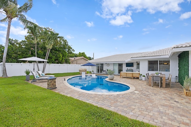 view of swimming pool featuring a patio, a yard, and an outdoor hangout area