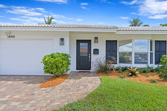 view of exterior entry with a garage