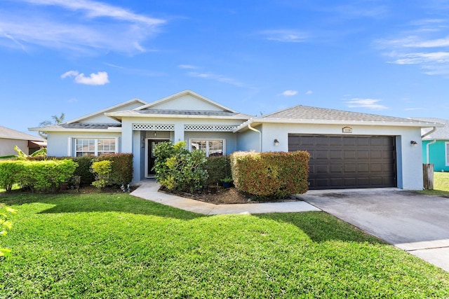 view of front of house with a front yard and a garage