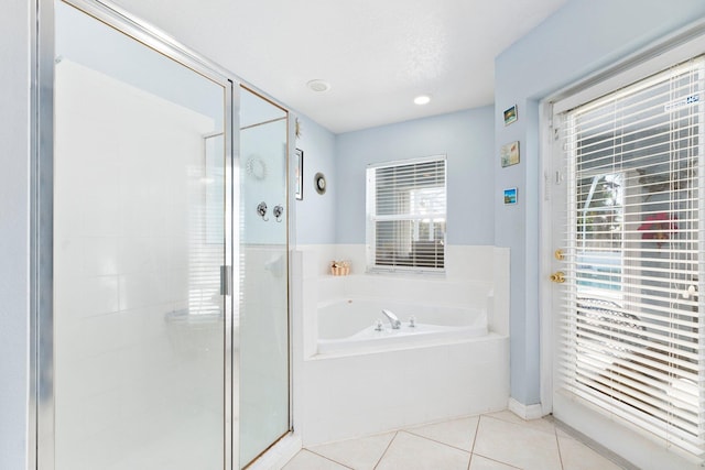 bathroom with tile patterned floors and shower with separate bathtub