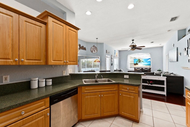 kitchen featuring kitchen peninsula, stainless steel dishwasher, ceiling fan, light tile patterned flooring, and sink