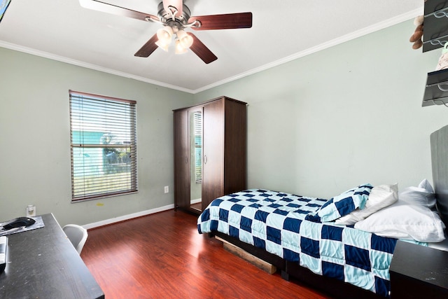 bedroom with dark wood-type flooring, ceiling fan, and crown molding