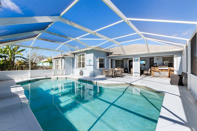 view of pool featuring a lanai, a grill, exterior kitchen, and a patio