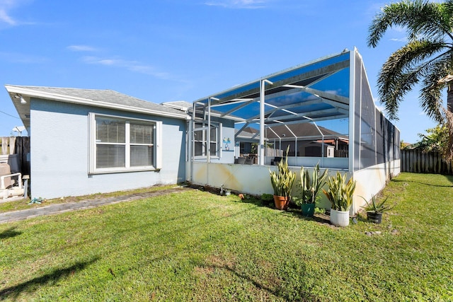 exterior space featuring a front yard and glass enclosure