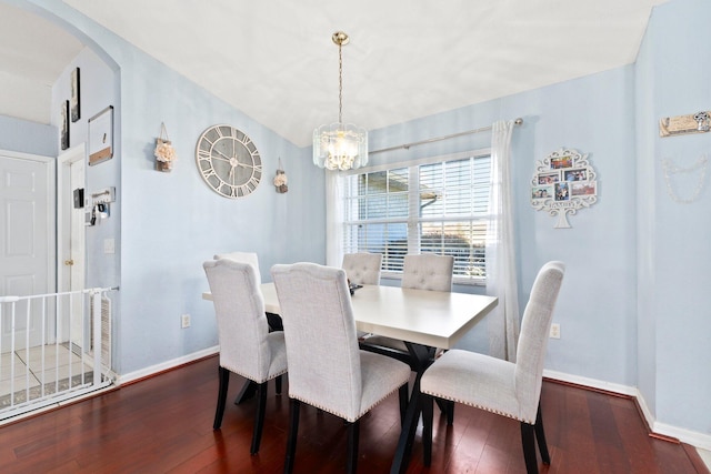 dining space featuring a notable chandelier and dark wood-type flooring