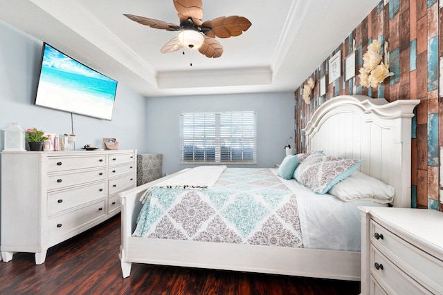 bedroom featuring a raised ceiling, ceiling fan, crown molding, and dark hardwood / wood-style floors