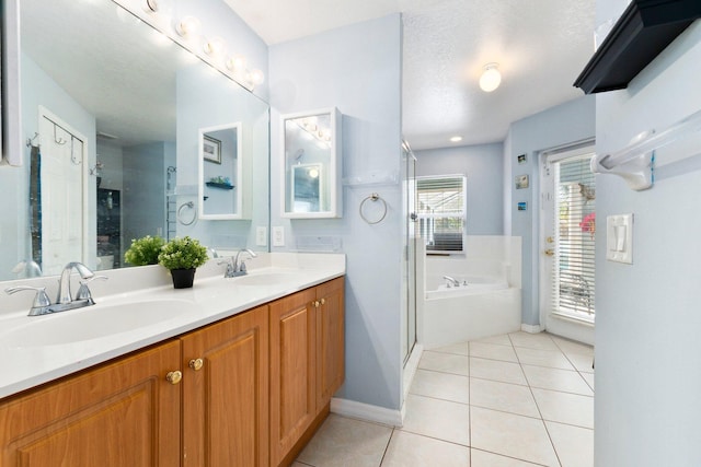 bathroom with a textured ceiling, separate shower and tub, tile patterned flooring, and vanity