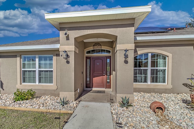 doorway to property featuring solar panels