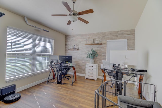 home office with ceiling fan, vaulted ceiling, and hardwood / wood-style flooring