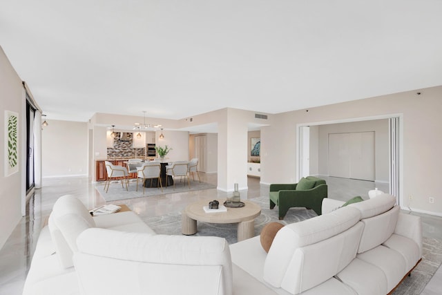 living room featuring a notable chandelier