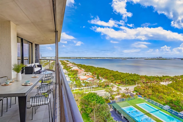 balcony with a water view and an outdoor living space