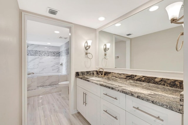 bathroom featuring toilet and vanity