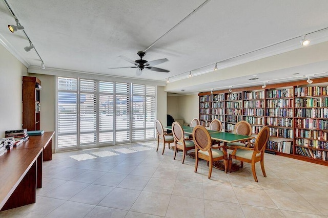 tiled dining room featuring ceiling fan and crown molding