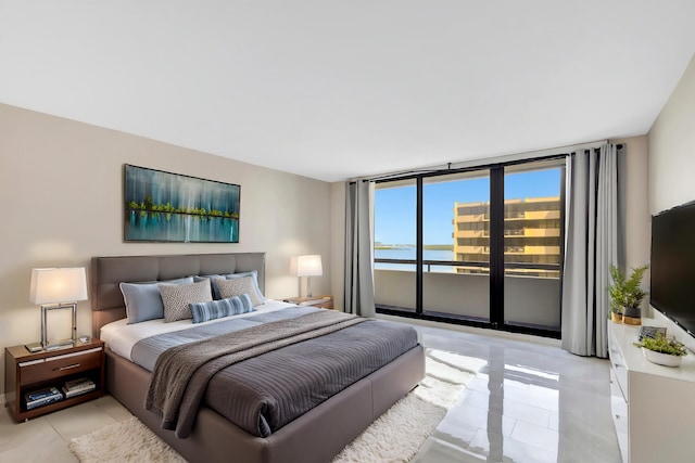 tiled bedroom featuring access to outside and expansive windows