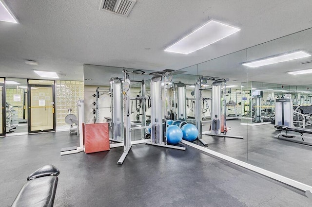 workout area featuring a textured ceiling