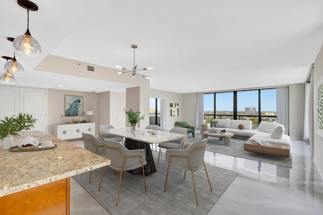 dining space featuring a wall of windows and a notable chandelier