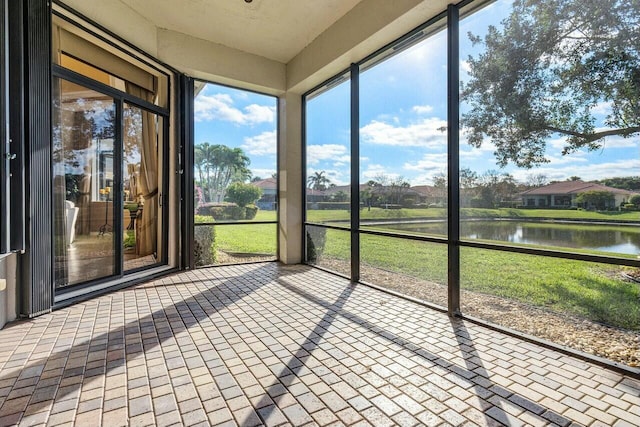 unfurnished sunroom with a water view