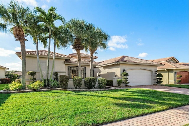 mediterranean / spanish home with a garage and a front yard