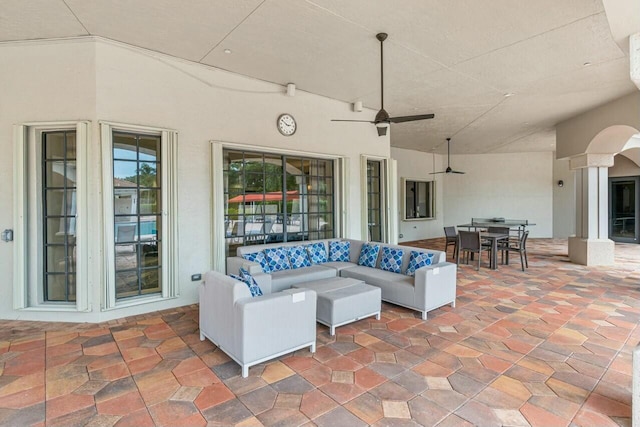 view of patio with ceiling fan and an outdoor living space