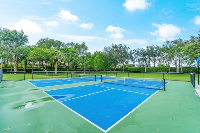 view of tennis court featuring basketball hoop