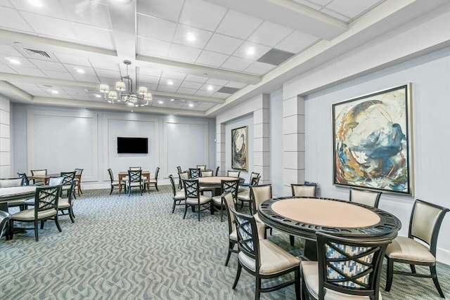 dining room featuring beamed ceiling, carpet floors, and a notable chandelier