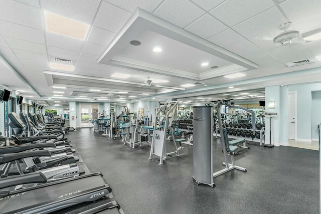 workout area with ceiling fan, crown molding, and a paneled ceiling