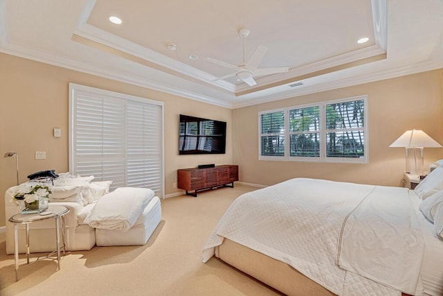 carpeted bedroom with ceiling fan, a raised ceiling, and crown molding