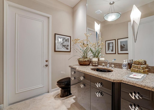 bathroom with tile patterned flooring, vanity, and toilet