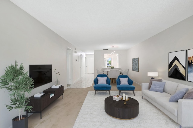 living room featuring a textured ceiling, a chandelier, and light colored carpet