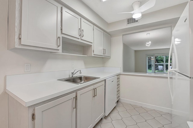 kitchen with sink, white appliances, and white cabinetry