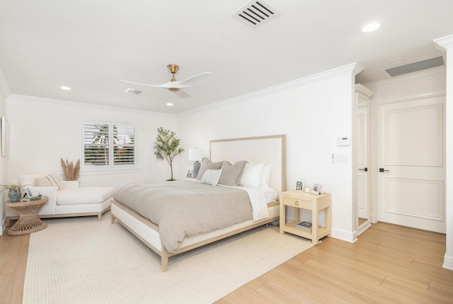 bedroom featuring ceiling fan, wood-type flooring, and ornamental molding