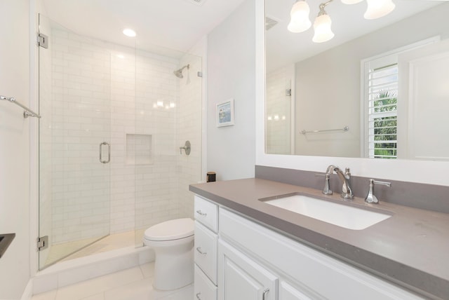 bathroom featuring an enclosed shower, vanity, tile patterned flooring, and toilet