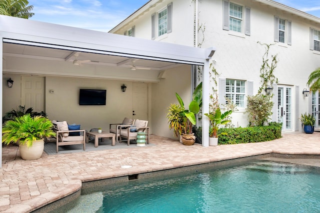 rear view of property with ceiling fan, an outdoor hangout area, and a patio area