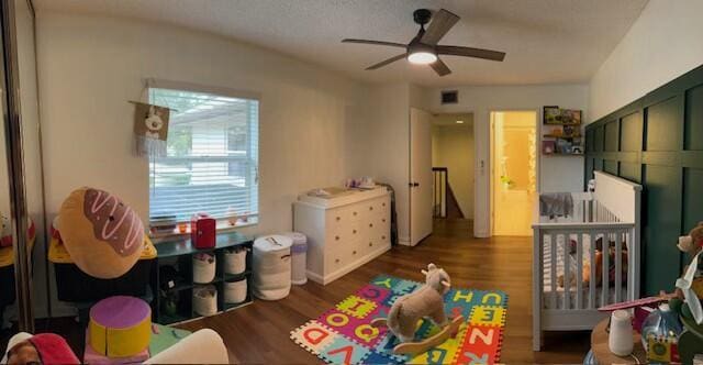 playroom featuring ceiling fan and dark hardwood / wood-style floors