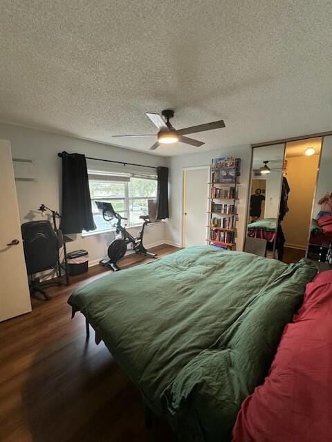 bedroom with hardwood / wood-style flooring, ceiling fan, a textured ceiling, and a closet