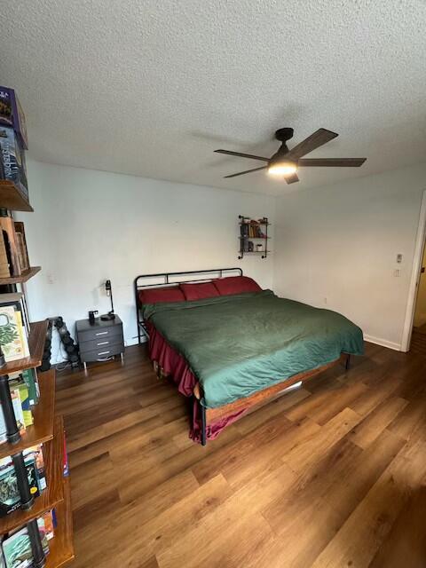 bedroom with hardwood / wood-style floors and a textured ceiling