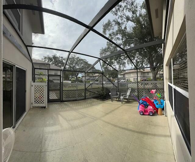 view of patio with glass enclosure