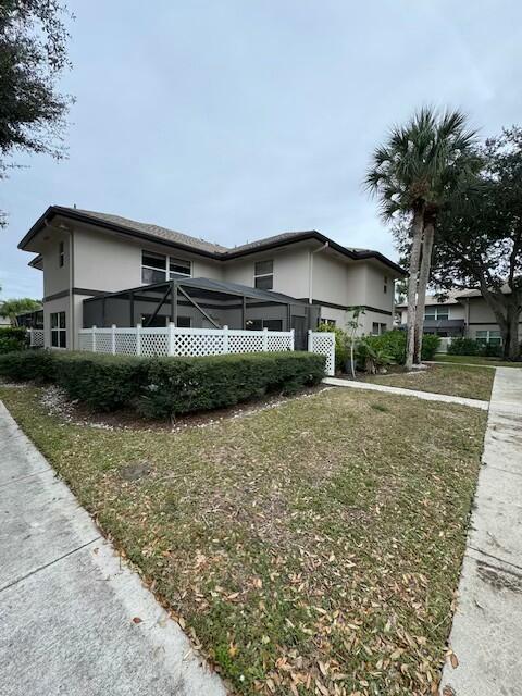 view of side of home with a lawn