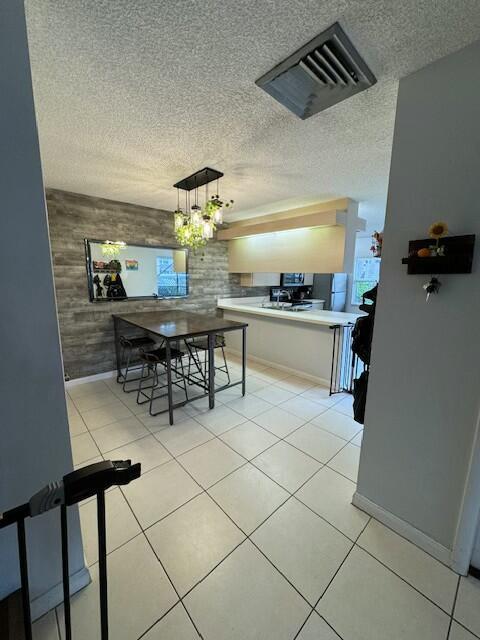 dining area with light tile patterned floors and a notable chandelier