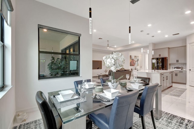 dining space with light tile patterned floors and sink