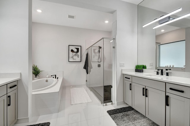 bathroom featuring vanity, tile patterned floors, and plus walk in shower