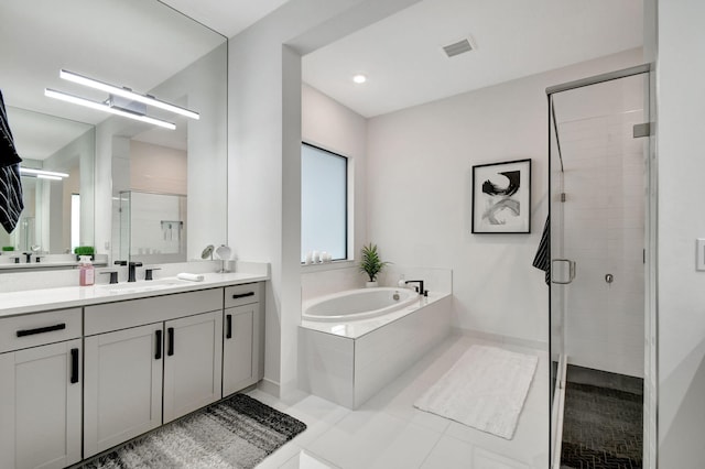 bathroom with tile patterned flooring, shower with separate bathtub, and vanity